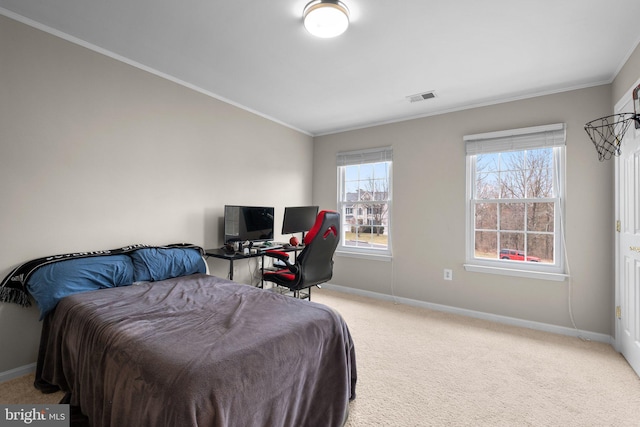 carpeted bedroom featuring visible vents, crown molding, and baseboards