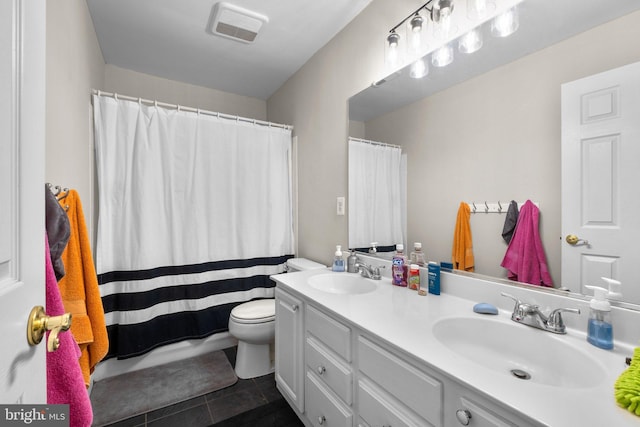 bathroom with double vanity, visible vents, a sink, and tile patterned floors