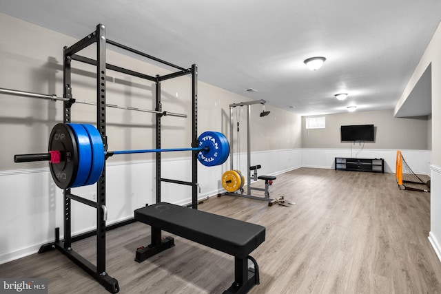 exercise area featuring visible vents and wood finished floors