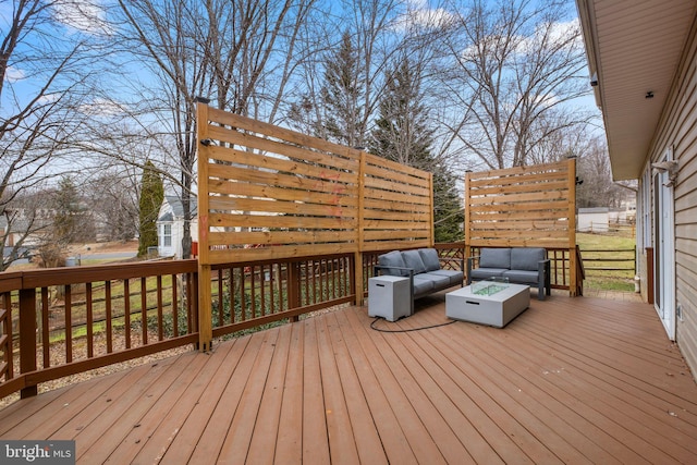 wooden deck with an outdoor living space with a fire pit