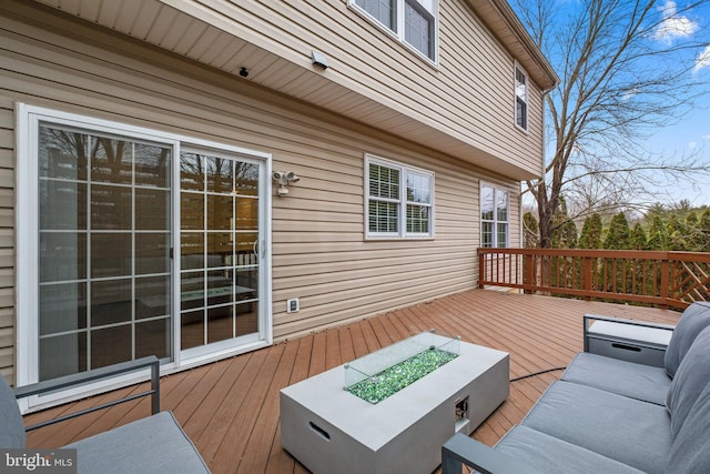 wooden deck with an outdoor living space with a fire pit