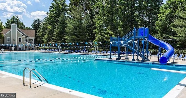 community pool with playground community and a water slide