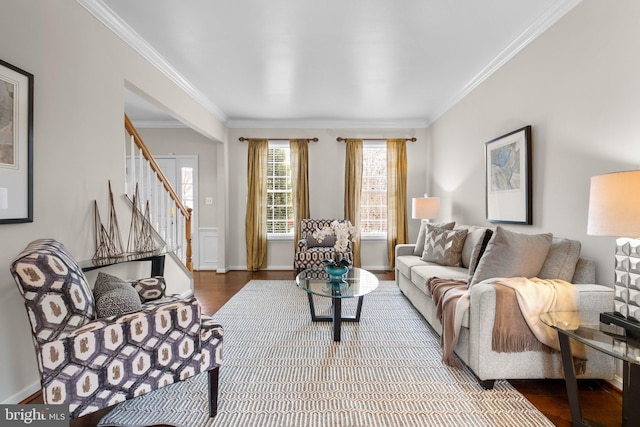 living room with ornamental molding, stairway, baseboards, and wood finished floors