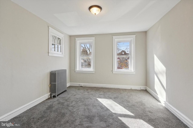 unfurnished room with carpet, baseboards, and radiator heating unit