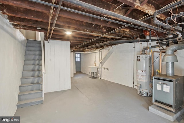 below grade area with water heater, a sink, and stairway