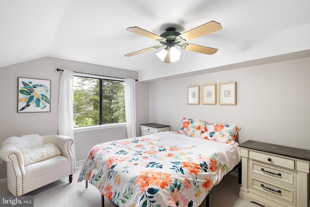 bedroom featuring lofted ceiling, a ceiling fan, and light colored carpet