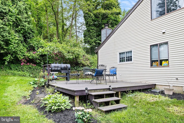 wooden deck with a lawn