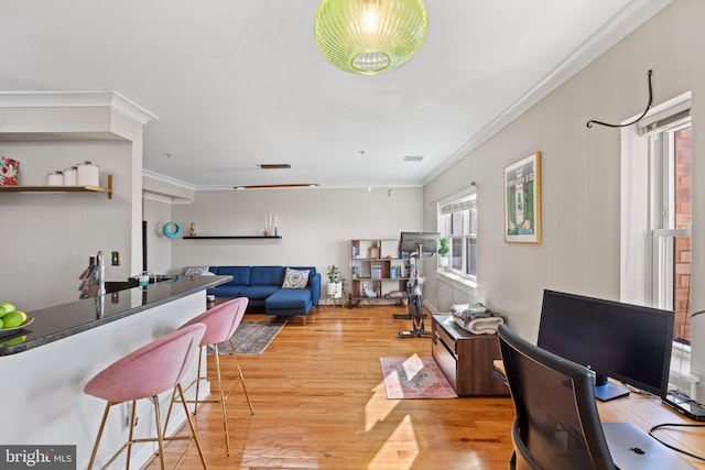 interior space featuring crown molding, visible vents, and light wood-style floors