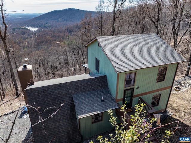 exterior space featuring a mountain view and a wooded view