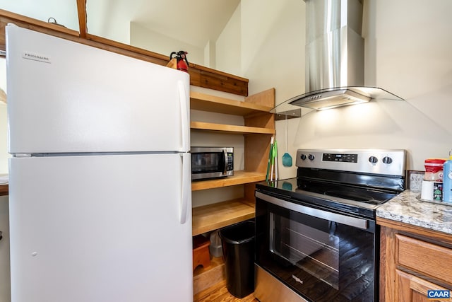 kitchen featuring appliances with stainless steel finishes, wall chimney exhaust hood, and open shelves