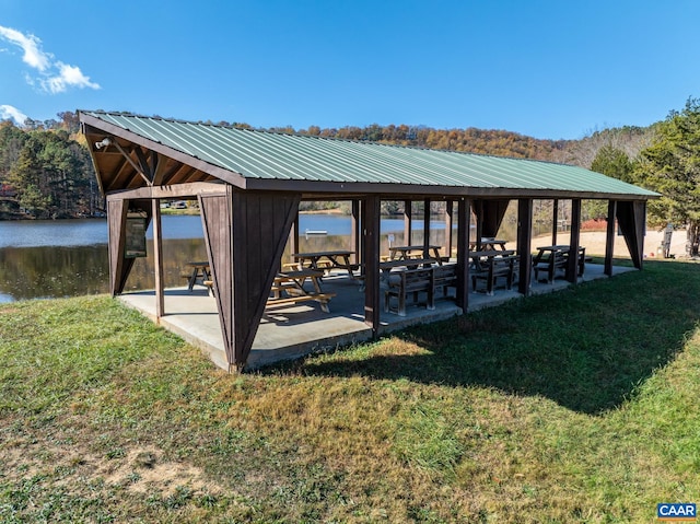 exterior space featuring a gazebo, a yard, and a water view