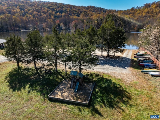 drone / aerial view featuring a forest view and a water view