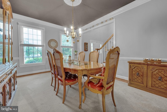 dining room featuring light colored carpet, baseboards, stairs, ornamental molding, and an inviting chandelier