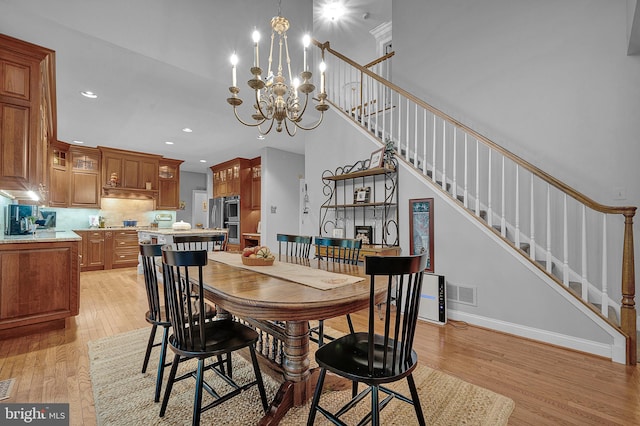 dining space featuring visible vents, baseboards, stairway, light wood-type flooring, and recessed lighting