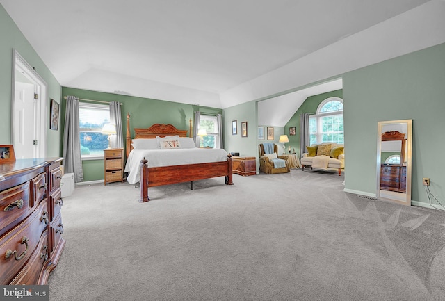 carpeted bedroom featuring baseboards and vaulted ceiling