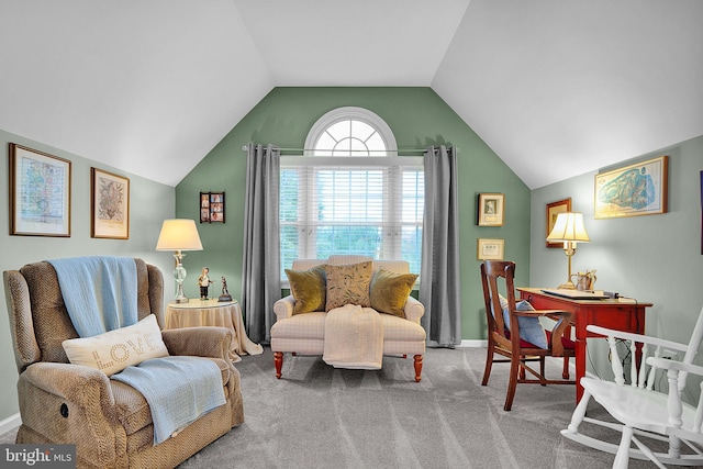 living area with carpet, baseboards, and vaulted ceiling