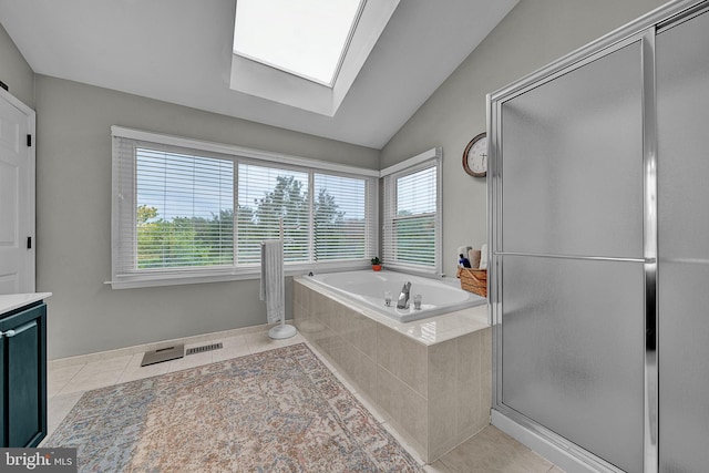 full bath with lofted ceiling with skylight, tile patterned flooring, vanity, a shower stall, and a bath