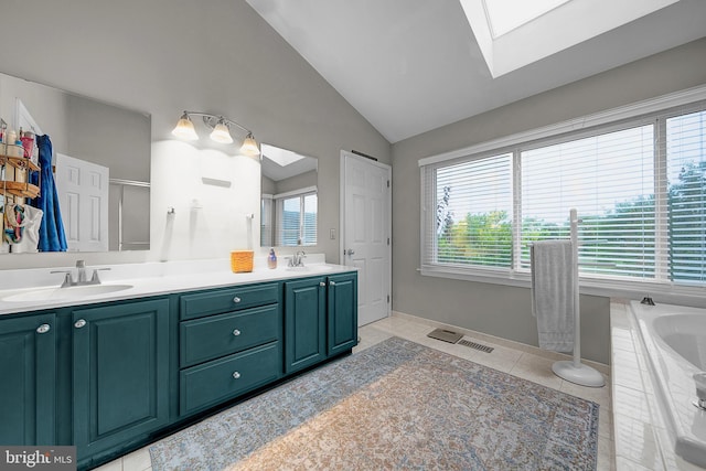 full bath with lofted ceiling with skylight, tile patterned flooring, a sink, and double vanity