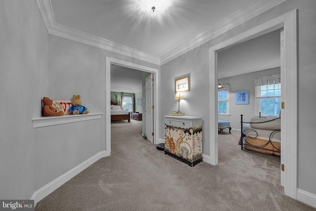 hallway featuring carpet floors, crown molding, and baseboards