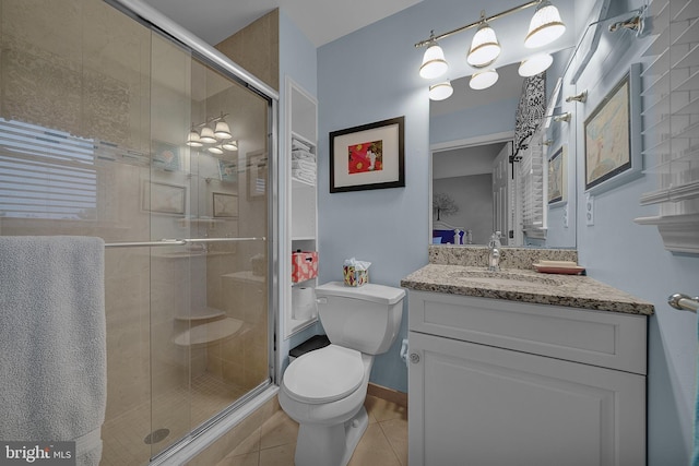 bathroom with a stall shower, baseboards, toilet, tile patterned floors, and vanity