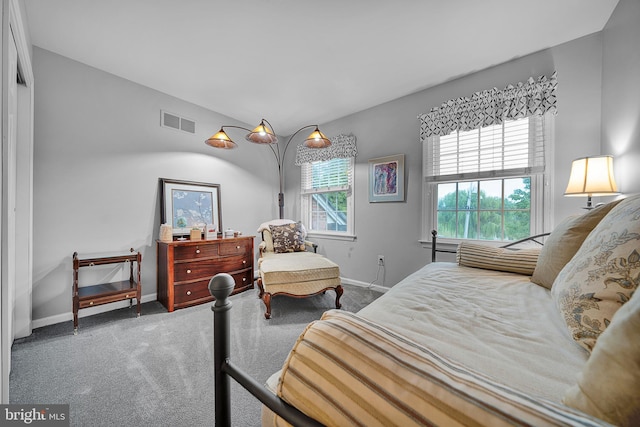 carpeted bedroom with visible vents and baseboards