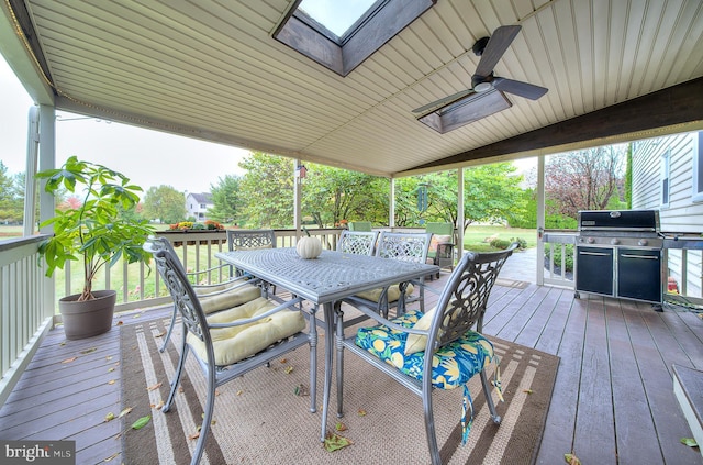 wooden terrace featuring ceiling fan, outdoor dining area, and area for grilling