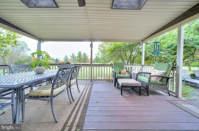 wooden terrace featuring outdoor dining area