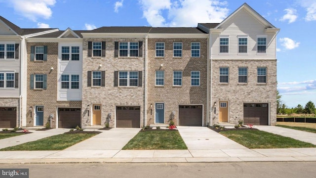 view of property with driveway and brick siding