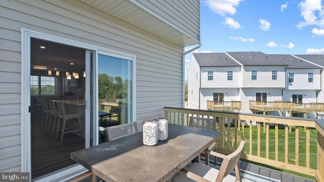 wooden terrace with a residential view and outdoor dining area