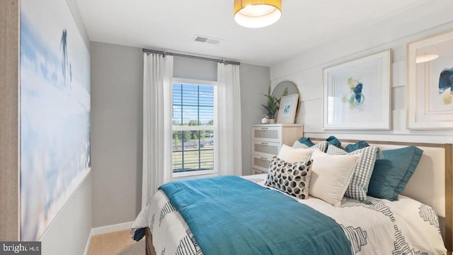 bedroom with carpet floors, visible vents, and baseboards