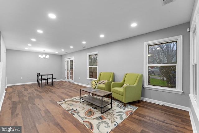 living area featuring baseboards, wood finished floors, and recessed lighting