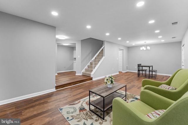 living room featuring stairs, wood finished floors, visible vents, and recessed lighting