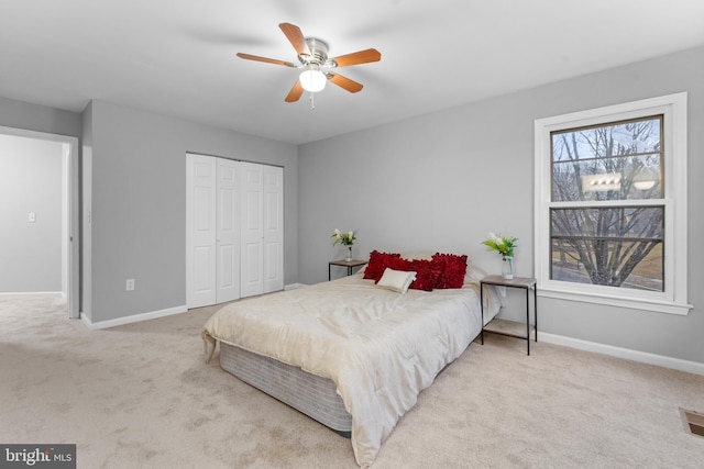 bedroom with carpet, multiple windows, and baseboards