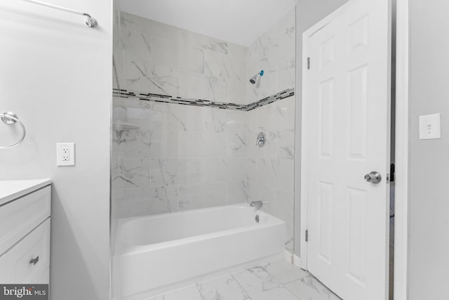 bathroom with marble finish floor, shower / bathing tub combination, and vanity