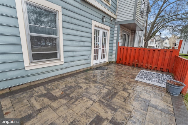 view of patio / terrace featuring french doors and fence