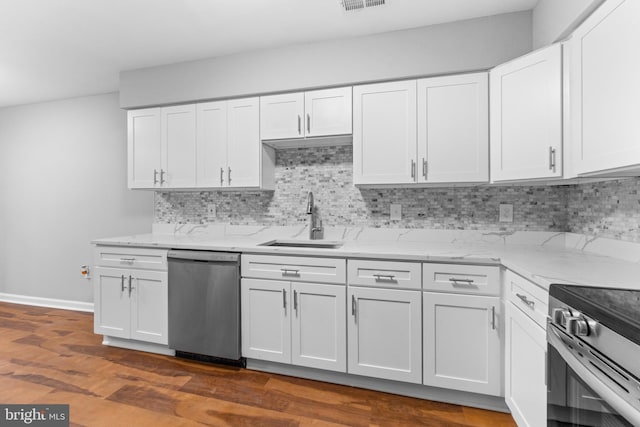 kitchen featuring stainless steel appliances, white cabinetry, and a sink