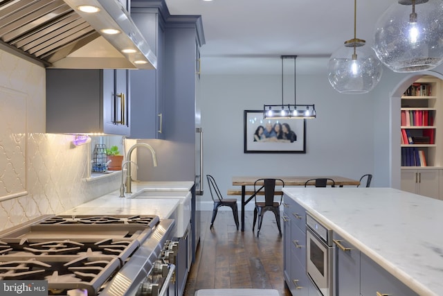 kitchen featuring high end stove, blue cabinetry, dark wood-style floors, arched walkways, and wall chimney range hood