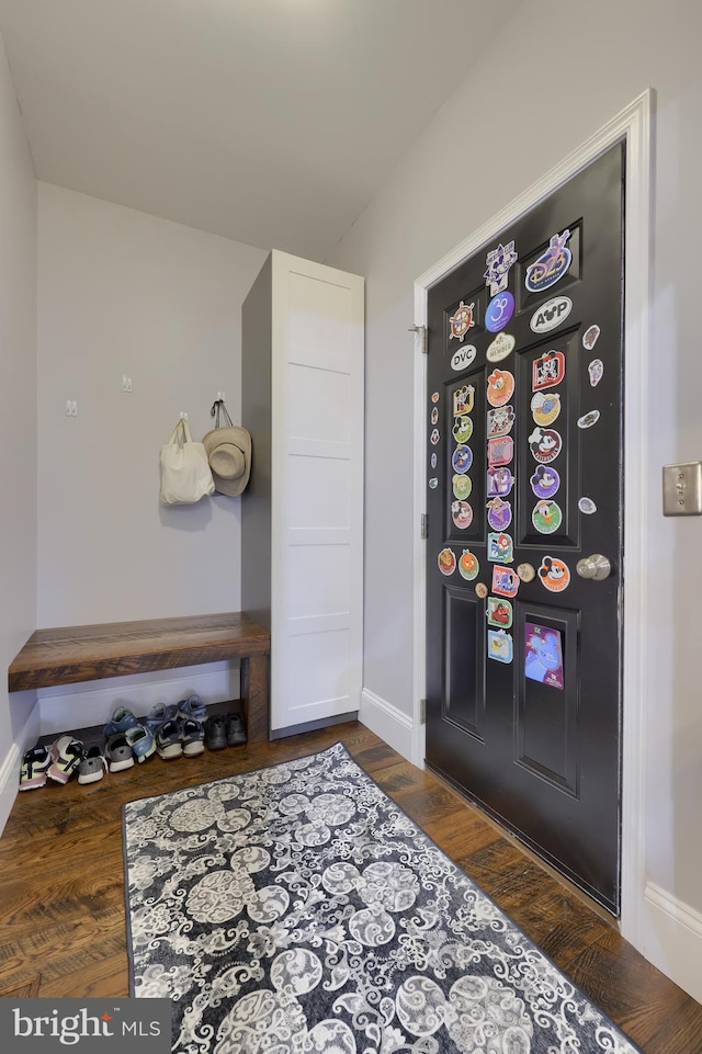 interior space with baseboards and wood finished floors