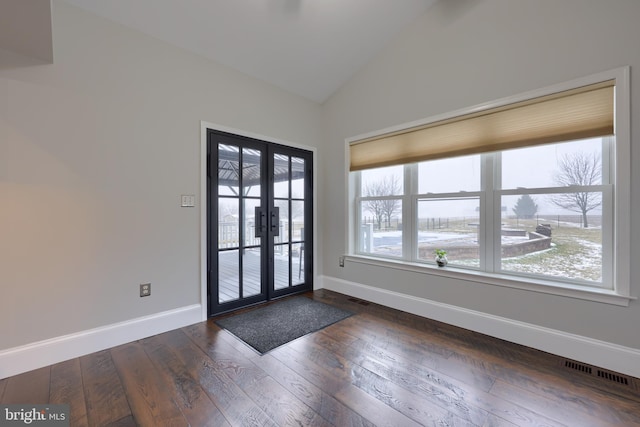 entryway with dark wood-style floors, visible vents, baseboards, and lofted ceiling