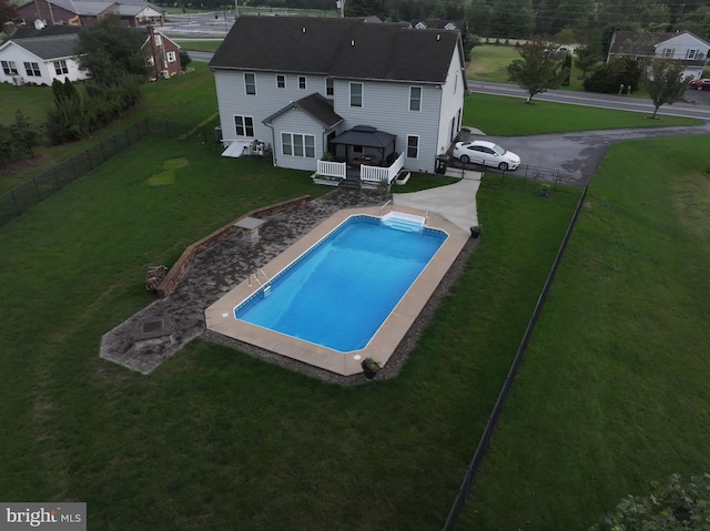 view of pool with a deck, a fenced backyard, a gazebo, a yard, and a fenced in pool