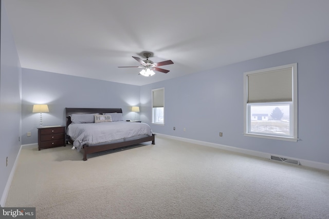 bedroom with a ceiling fan, carpet flooring, baseboards, and visible vents