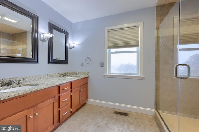 full bath with a sink, visible vents, and a stall shower