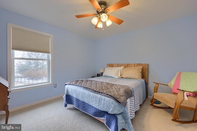 bedroom with baseboards, carpet floors, and a ceiling fan