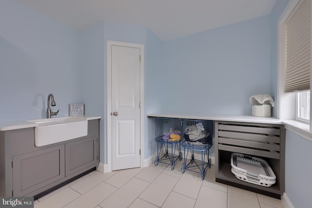 interior space with baseboards and a sink