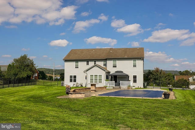 back of house featuring a lawn, fence, a gazebo, a fire pit, and a patio area