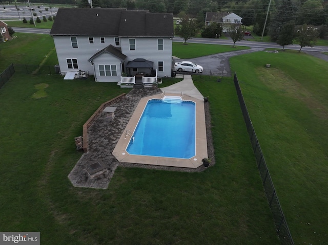 view of pool featuring a lawn, a fenced backyard, and a fenced in pool