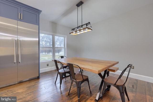 dining room featuring dark wood finished floors and baseboards