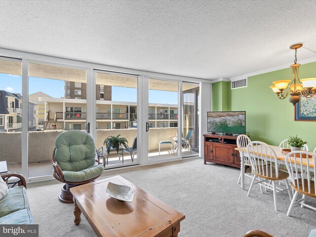 8500 Coastal Hwy Unit 107, Ocean City, MD 21842 - carpeted living area featuring a notable chandelier, a wall of windows, a textured ceiling, visible vents, and ornamental molding