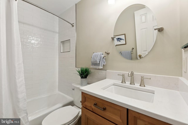 full bathroom featuring toilet, shower / bath combination with curtain, and vanity