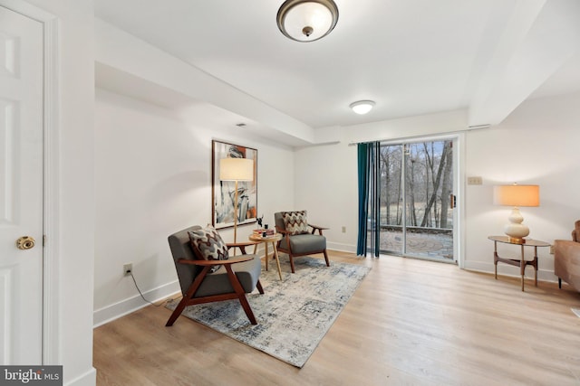 sitting room featuring baseboards and wood finished floors